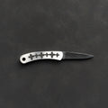 A small folding pocket knife with a silver handle featuring a row of black floral or cross-like cutouts, and a metal blade, displayed horizontally on a dark textured background.