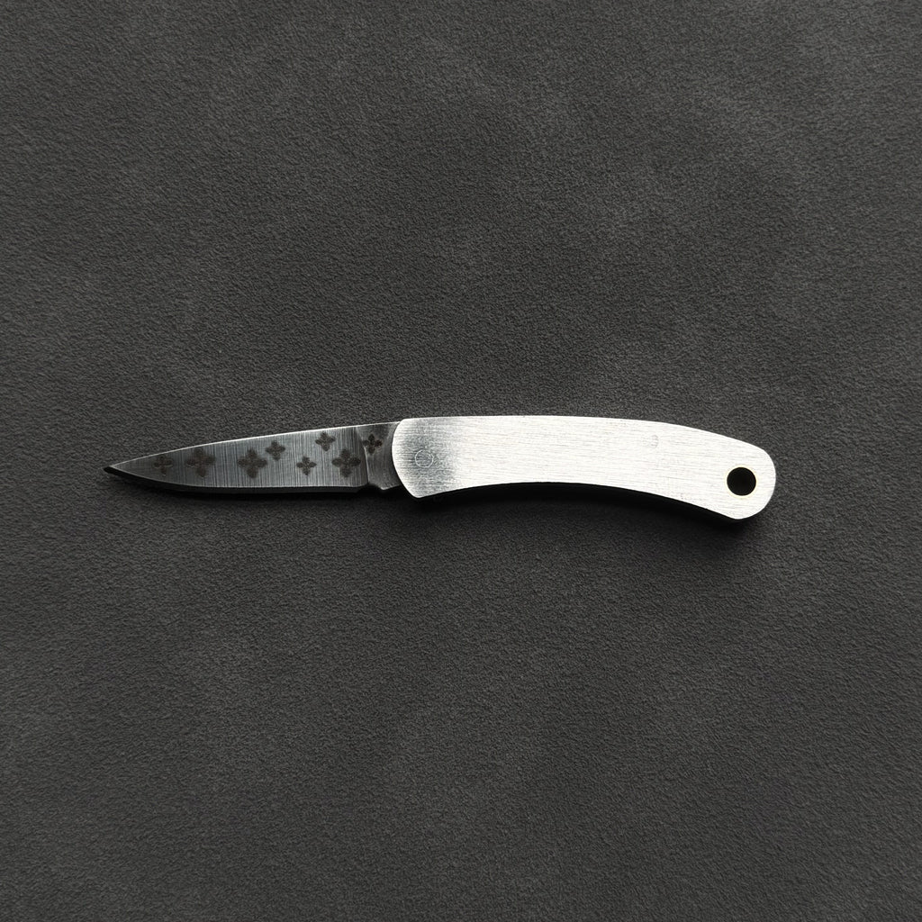 A small folding pocket knife with a satin-finished silver handle and a partially serrated steel blade, displayed horizontally on a dark textured background.